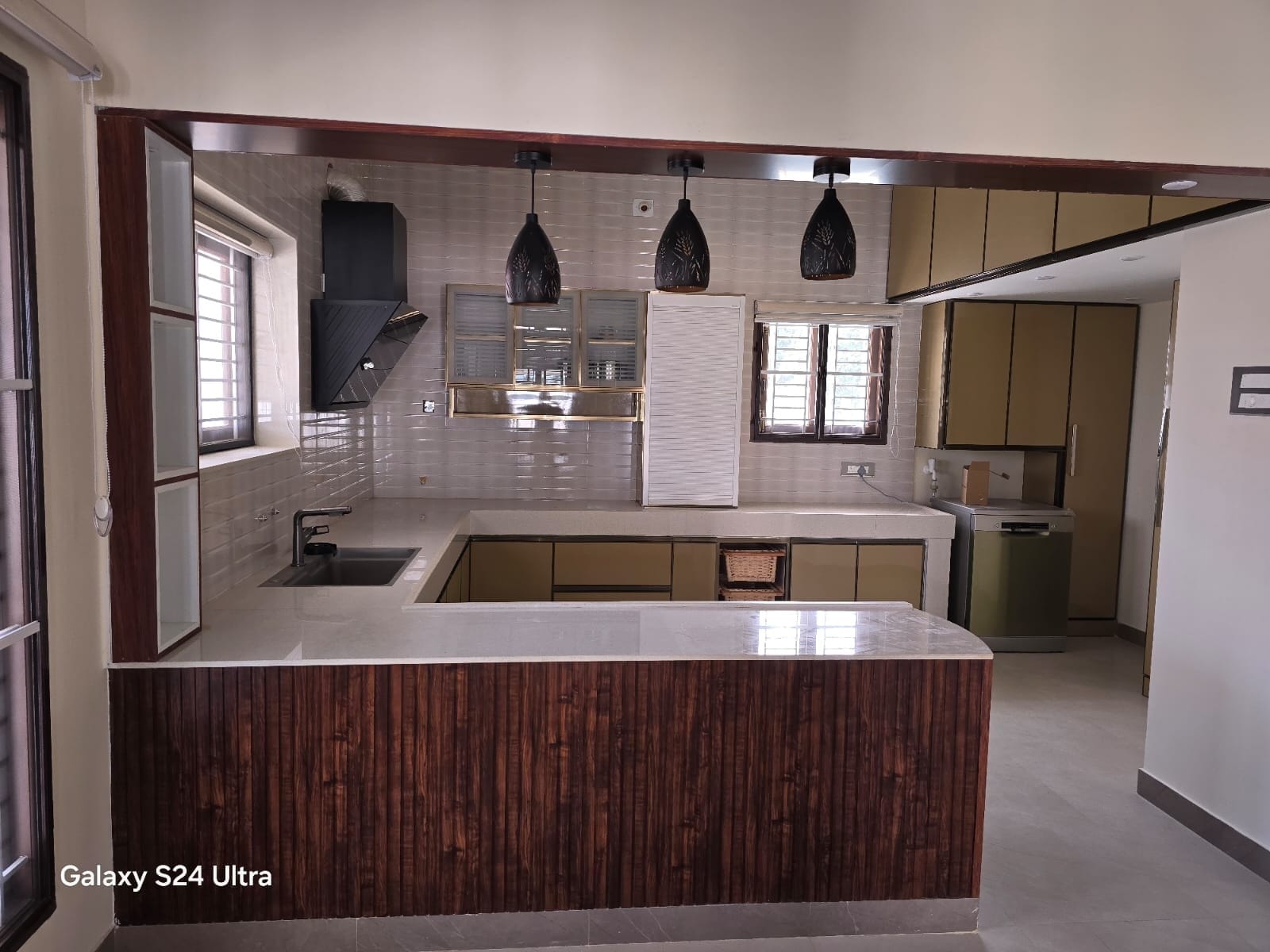 Warm modular kitchen completed by Sri Lakshmi Interior Works